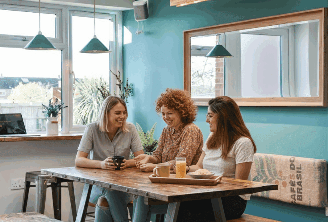 Professionals gathered around a table in a B-Hive Living shared space
